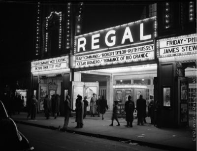 Black and White Photo of a Movie Theater with Marquee Lights